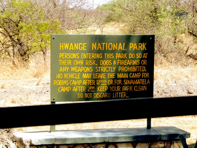 a sign on a wooden bench